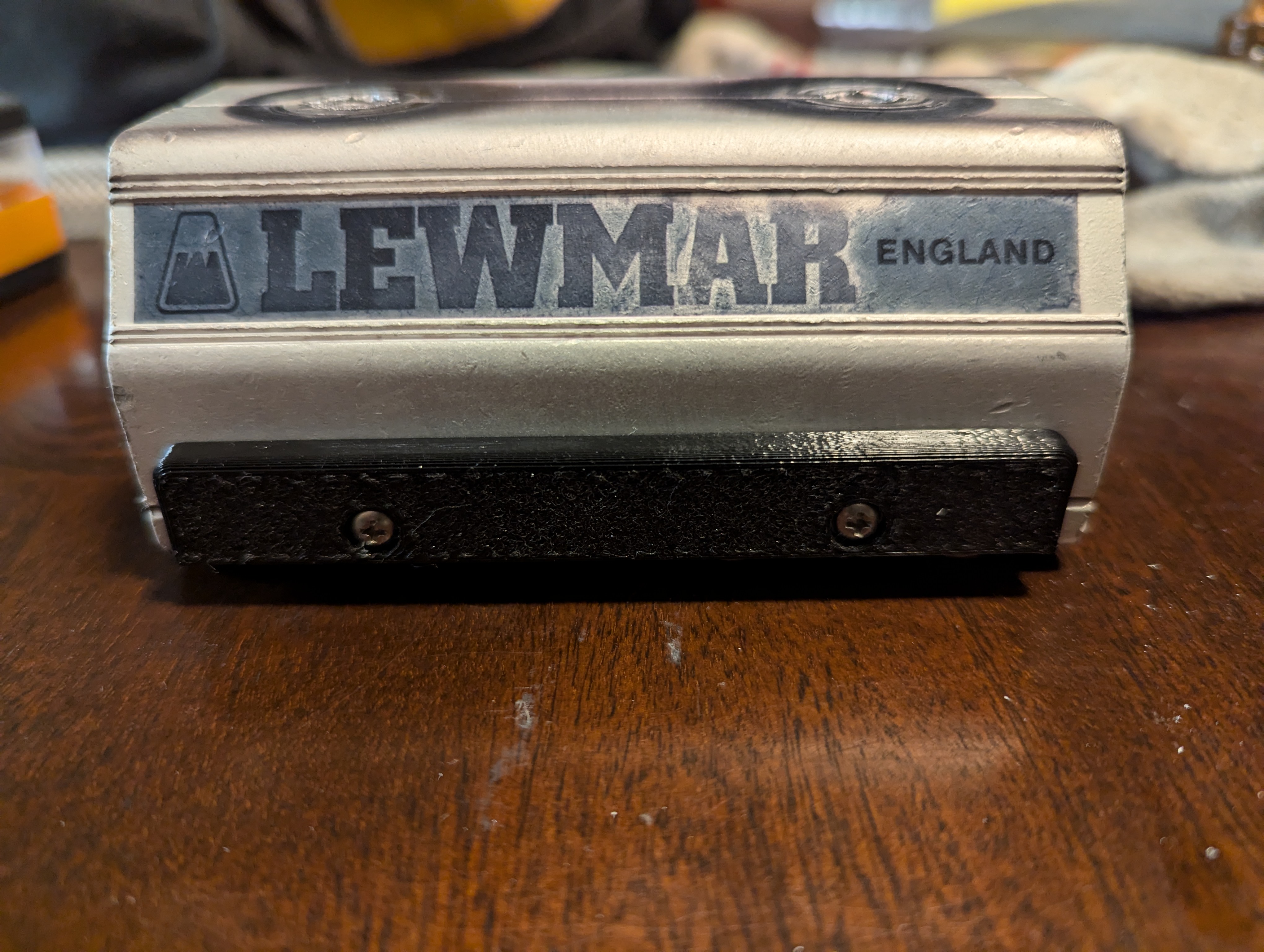 Exterior side of the car, highlighting the cover piece and two small screws holding it in place.